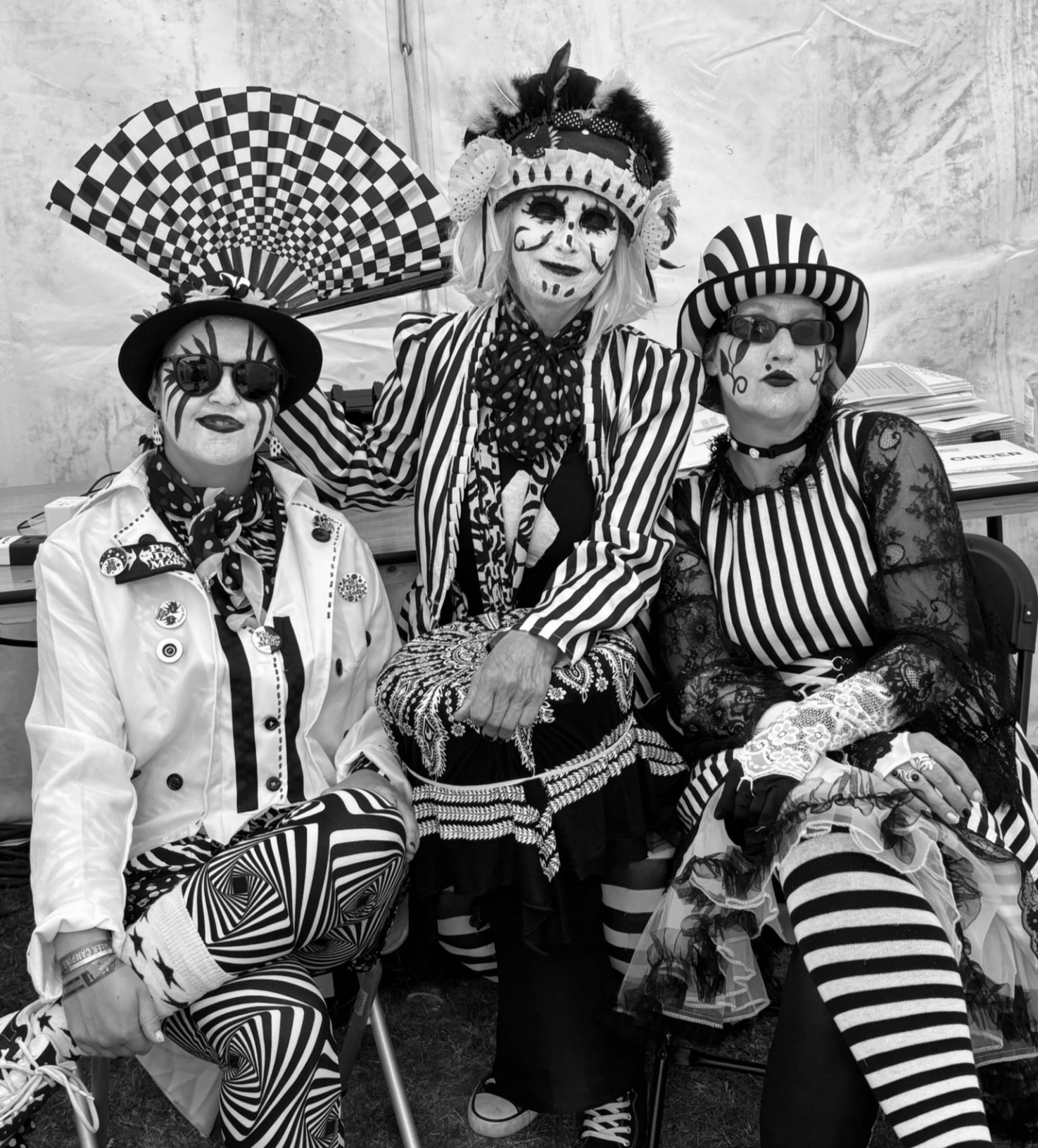 Three dancers posing in their fabulous black and white costumes